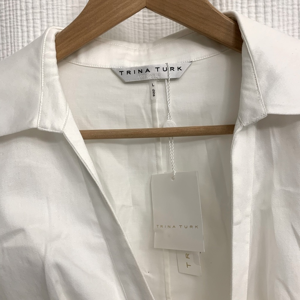 Trina Turk white cotton peplum style blouse.